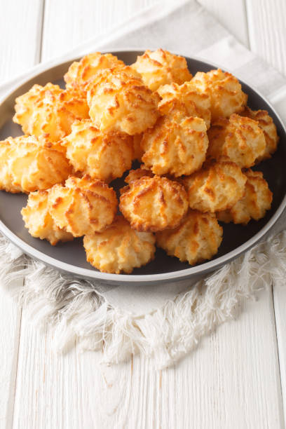 istock Delicious coconut macaroons cookies closeup on the plate. Vertical 1589992957