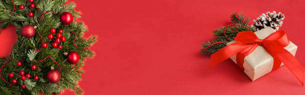 istock Christmas ring or wreath and gift box on the red background. Copy space. 1590005243