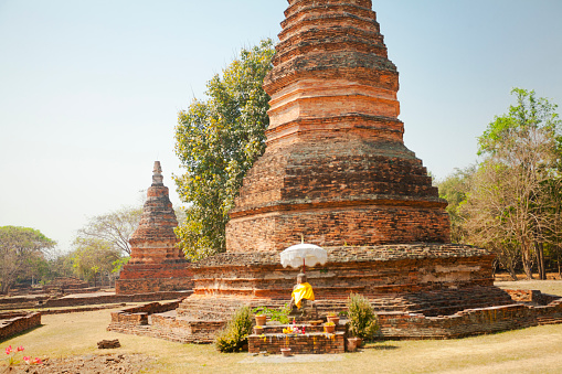 Thai buddha and old pagodas at Wat Wiang Tha Kan grounds and park,  a thousand year old historical site in south of Chiang Mai