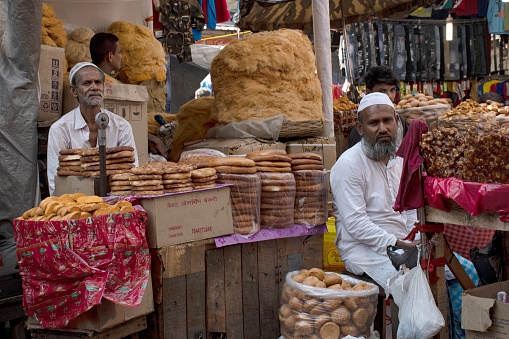 6th April, 2023, Kolkata, West Bengal, India: A old man of muslim religion selling a type of bread at the Zakaria street at the time of Ramadan.