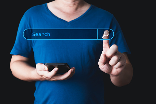 Searching Browsing Internet Data Information with blank search bar. hand of businessman working with smartphone . Search Engine Optimization SEO Networking Concept.