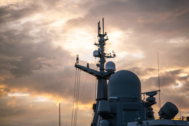 Navigation radar tower on warship at sunset close-up