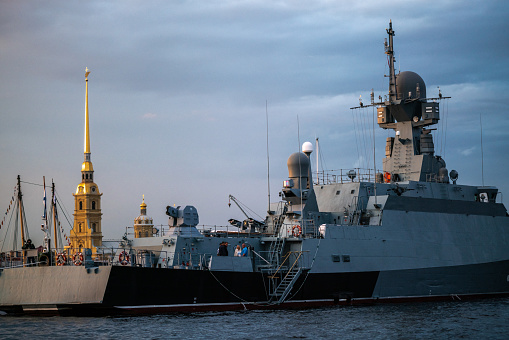 Military warship sailing in Neva River at St. Petersburg at sunset