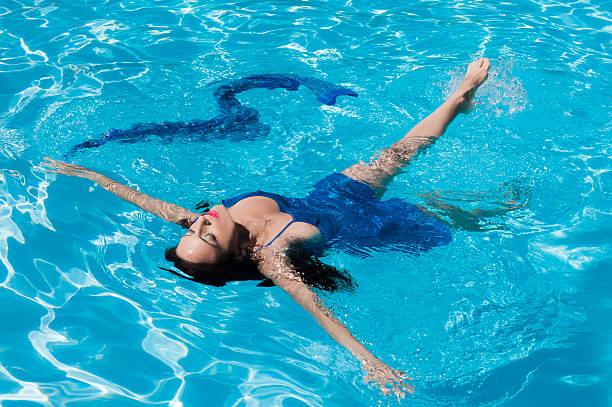 istock Girl relaxing in a swimming pool 159003688