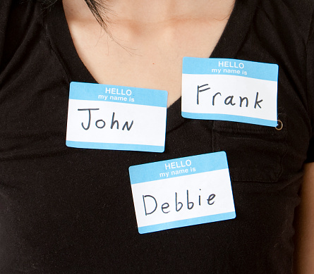 Women with name multiple name tags. Concept is identity theft.