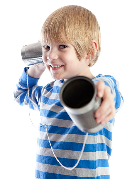 istock Boy holing one end of a tin can phone 159005426