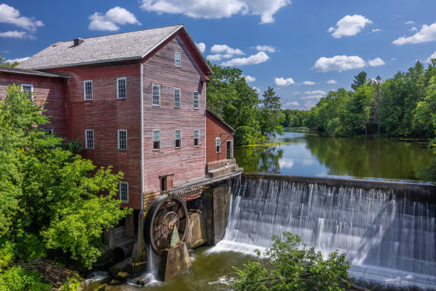 Dells Mill In Summer An old grist mill with water wheel and dam during summer. old flour mill stock pictures, royalty-free photos & images