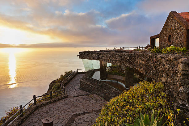 Mirador de la Peña, El Hierro Located 700 feet tall, the Mirador de la Peña is one of the most visited places on El Hierro and one of its the most scenographic landmarks. The building and its surrounding gardens were realized in 1989 by Cesar Manrique (1919-1992), famous architect and artist native of Lanzarote, who chose stone and wood as construction materials, thus following the traditional island architecture style. From here, haze permitting, you can enjoy spectacular images throughout the El Golfo area. Canon EOS 5D Mark II mirador stock pictures, royalty-free photos & images