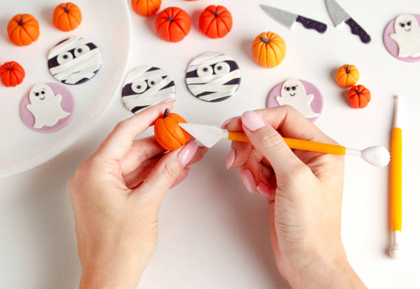 istock Sculpt halloween decor for cupcakes from mastic