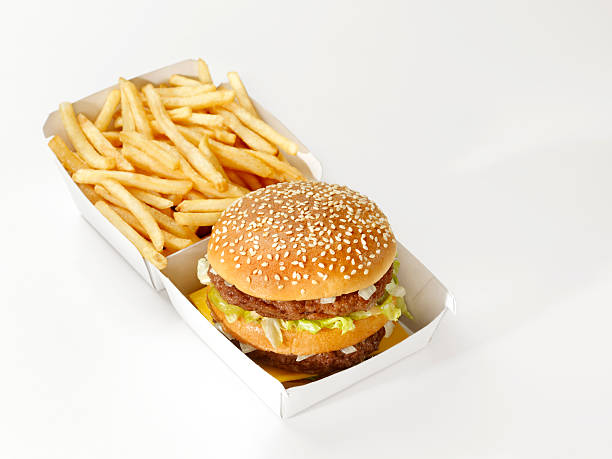 Big hamburger with french fries isolated on white background