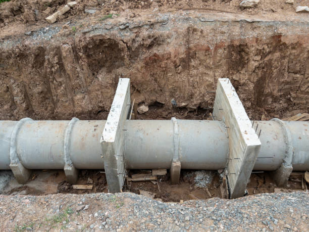 istock The concrete pipe under the dirt road for the irrigation system under construction. 1590097887