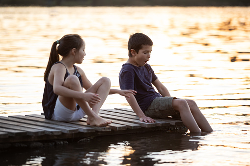 Two children playing on a lake dock - Buenos Aires - Argentina