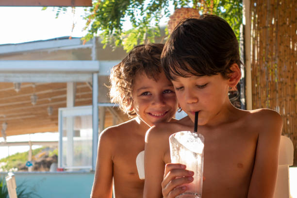 istock Brothers for milkshake cocktail on the beach 1590114401