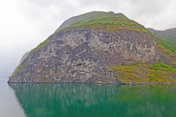 istock Granite Cliff on a Norwegian Fjord in evening mist 159011961