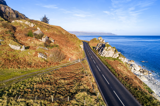Causeway Coastal Route a.k.a Antrim Coast Road A2 on the Atlantic coast in Northern Ireland. One of the most scenic coastal roads in Europe. Aerial view in winter