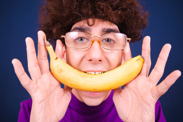 istock Funny emotional guy eats fruits and vegetables. 1590132466