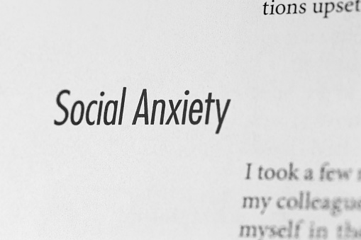Close-up of the text 'social anxiety' on a plain white paper background