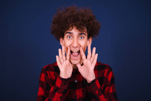 istock Funny emotional guy posing in the studio. 1590137489