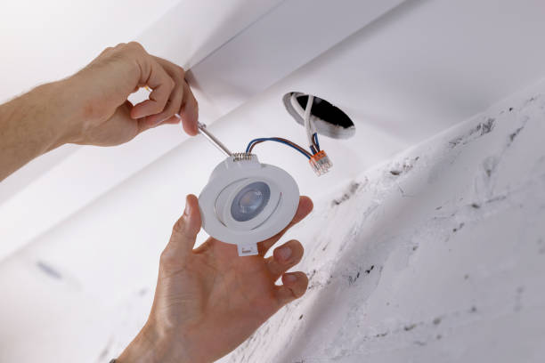 istock electrician installing recessed lamp in drywall ceiling. led lighting 1590149146
