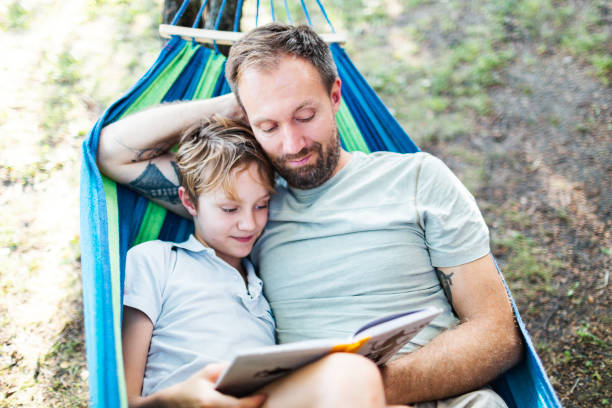 istock Father with son relaxing outdoors 1590171235