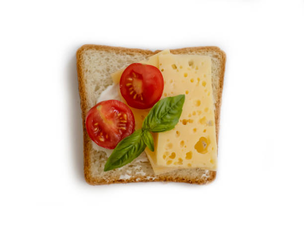 istock Sandwich with cheese, tomato, basil isolated on white background 1590176445
