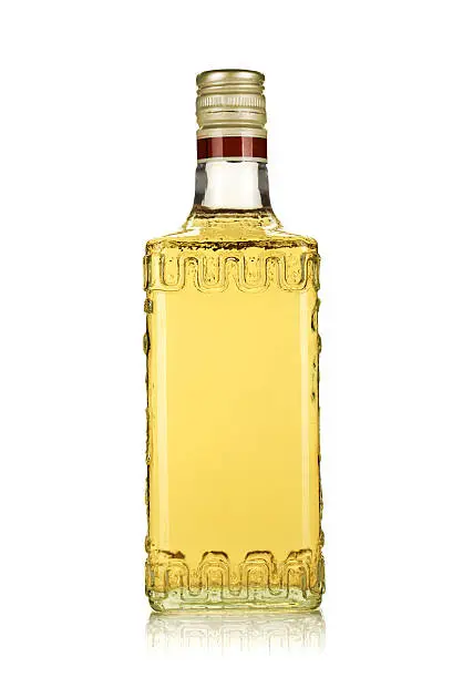 Photo of Generic bottle of gold tequila on a white surface