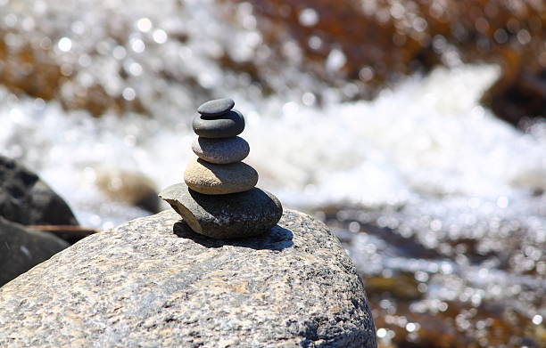 Stack of rocks by a riverside stock photo