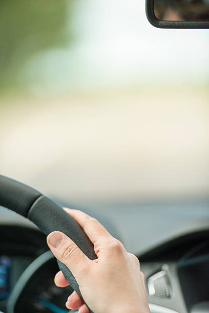 istock Hand of woman on steering wheel inside car 159021248