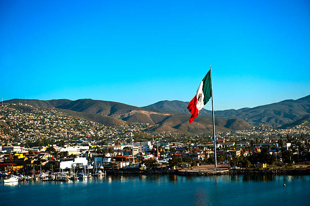 A large Mexican flag flying at the Port of Ensenada.