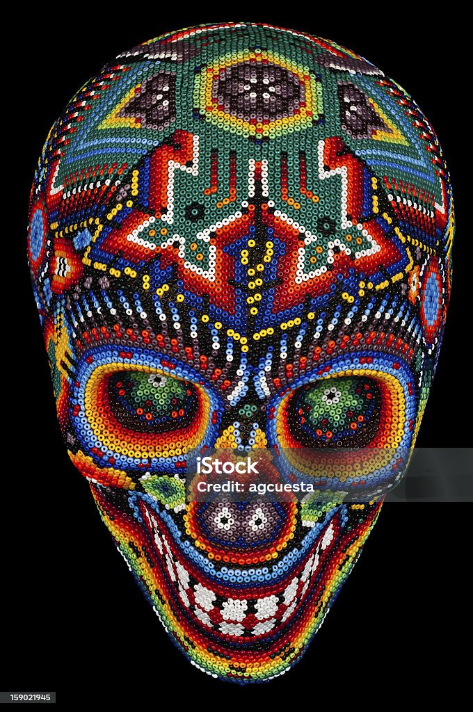 Beaded skull isolated on black Colorful Beaded Skull from mexican traditional huichol bead art, symbol of the day of the dead,  isolated on black Pattern Stock Photo