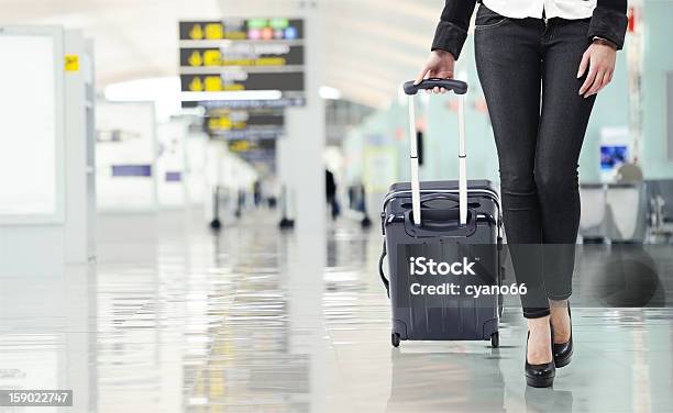 Young Woman Pulling Luggage At The Airport Stock Photo - Download Image Now - Wheeled Luggage, Adult, Airport