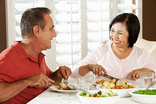 istock Senior Couple Enjoying Meal At Home 159022924