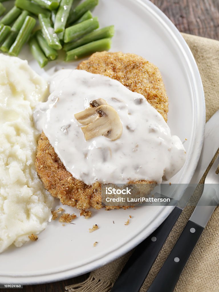 Country Fried Steak Country Fried Steak with Mushroom Gravy, Mashed Potaoes and Green Beans -Photographed on Hasselblad H3D2-39mb Camera Edible Mushroom Stock Photo