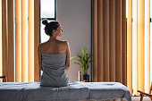 Beautiful Woman Sitting on the Massage Bed at the Spa