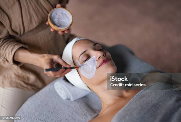 Beautiful Woman Enjoying Receiving A Facial Treatment At The Spa Stock Photo - Download Image Now