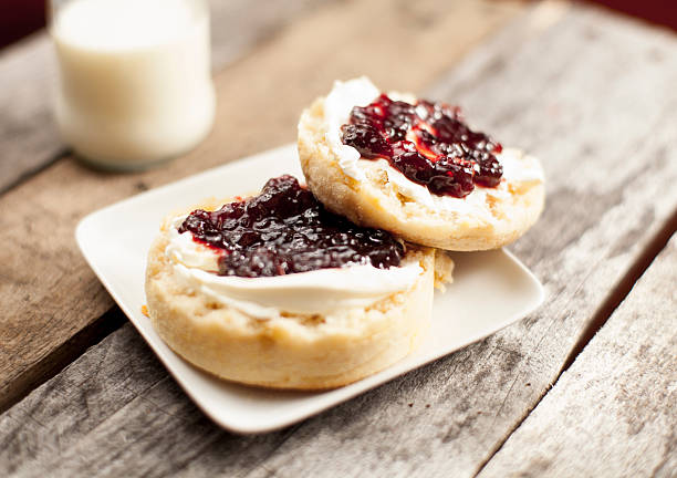 English Muffins English muffins with cream cheese and jelly with a bottle of milk in the background. english muffin stock pictures, royalty-free photos & images