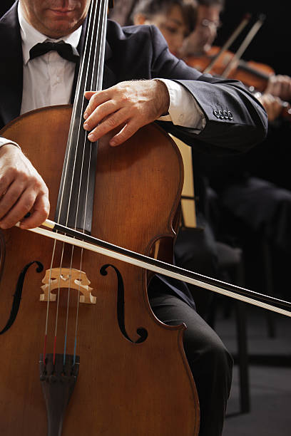istock Cellist and violinists playing in orchestra 159027924