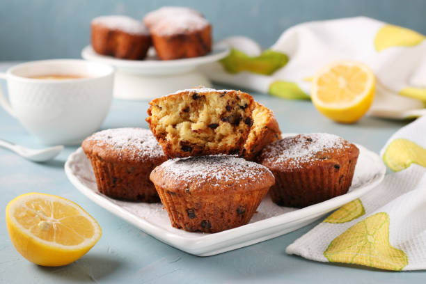 istock Homemade lemon muffins with chocolate on a white plate on a light blue background, Closeup 1590301961