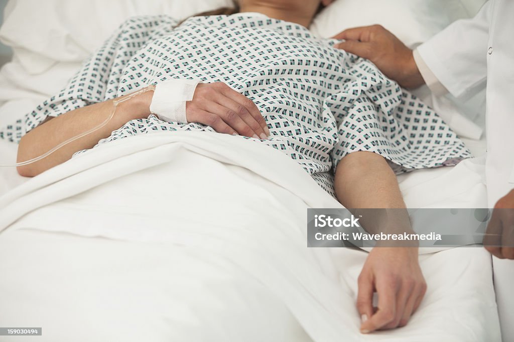 Old lady lying sick in bed Old sick lady lying in hospital bed Unconscious Stock Photo