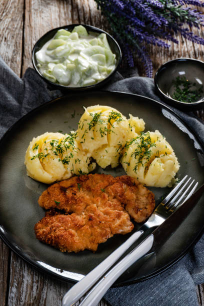 istock Pork chop served with mashed potatoes and cucumber salad. 1590311658