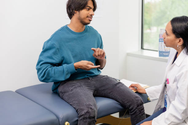 istock Deaf male patient uses sign language to communicate with doctor 1590331246