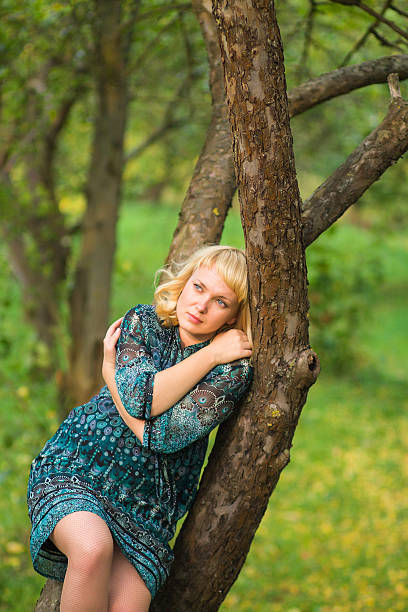 istock Sadness girl sitting on a tree branch 159033749