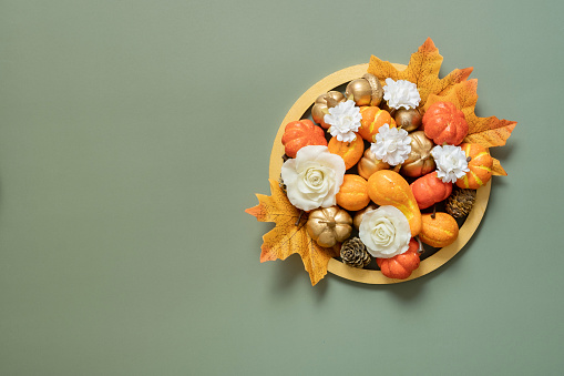Autumn or Thanksgiving decoration with mini pumpkins, nuts and spices