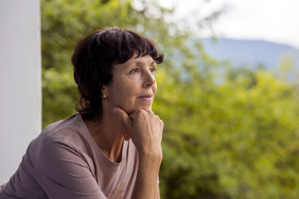 istock Resting woman seated outdoors on the balcony. 1590347968