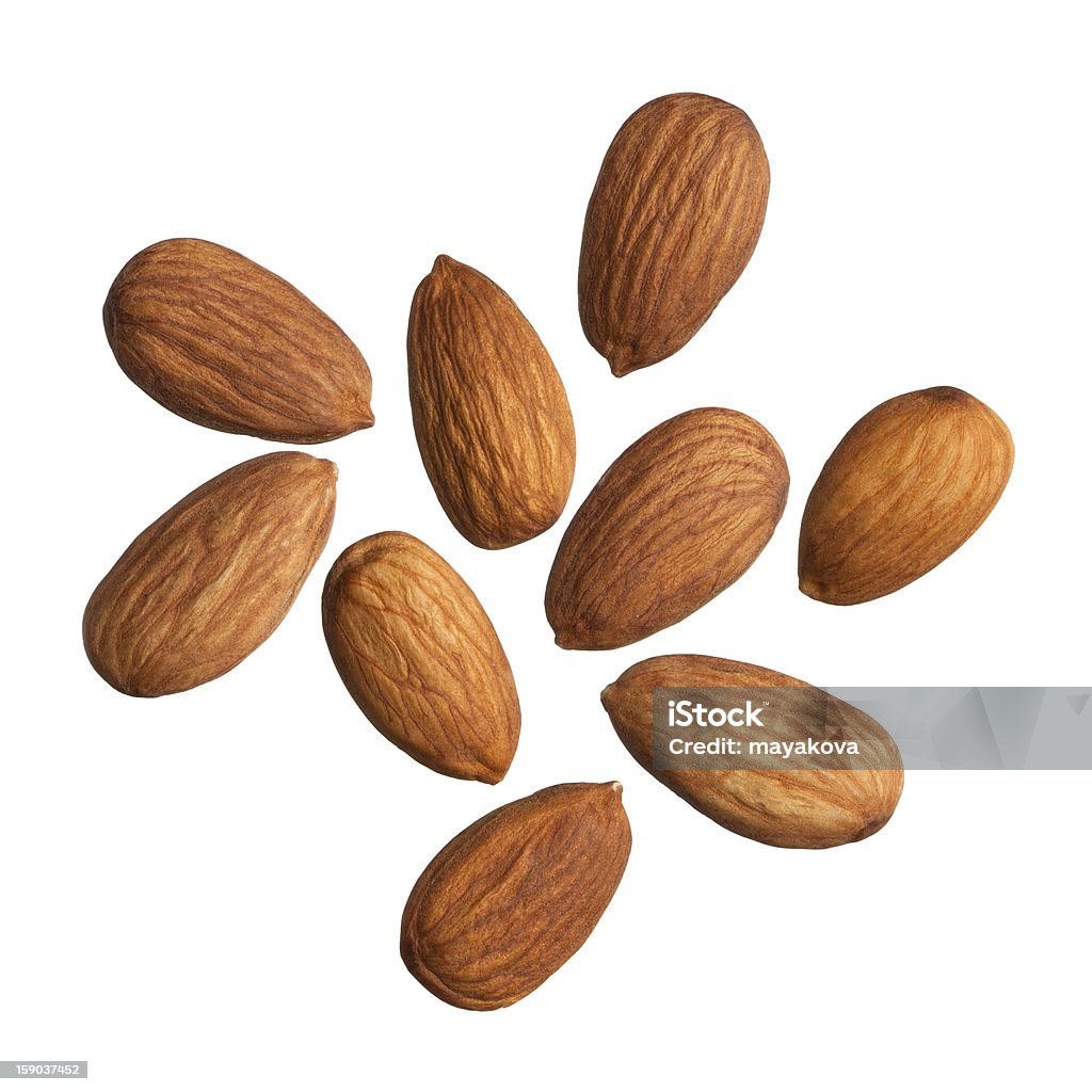 Nine scattered almonds on a white background Almonds isolated on white background. Almond Stock Photo