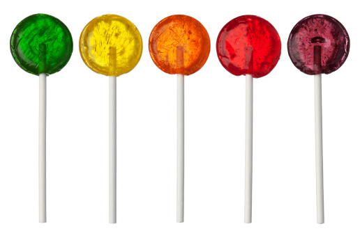 Assorted colors lollipops isolated on white background, close-up. This image is isolated with light during the photo shoot process.