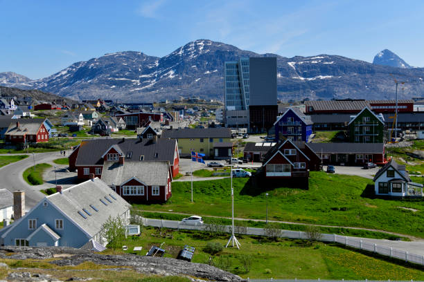 Nuuk / Godthåb, Sermersooq, Greenland: view of the Greenlandic capital from the Hans Egede hill - mix of colonial and modern buildings - mountains in the background and in the middle the Nuuk Center tower, home to the Government of Greenland. Also in the image the Parliament building, the Icelandic Consulate, the Fish Market, the old Seminary building...