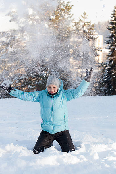 istock Smiling cute girl throwing snow 159040629