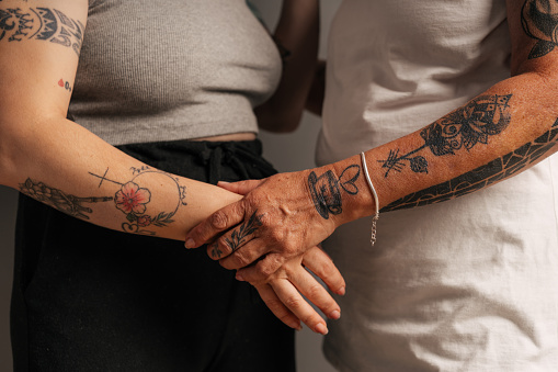Tattooed women embracing