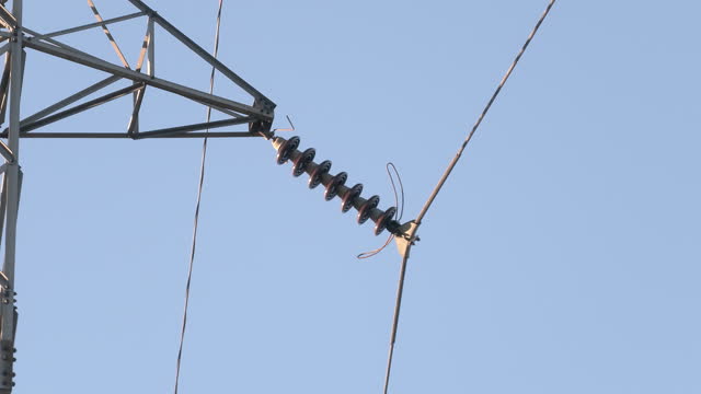 High voltage mast with cables and insulators. Rising energy prices